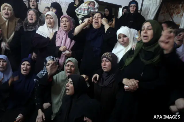 Palestinian female relatives of Ahmed Salim, one of the Nasser Salahaldin Brigades militants who was killed in an Israeli air strike, grieve during his funeral in Gaza City, on March 11, 2012. Photo by Ashraf Amra