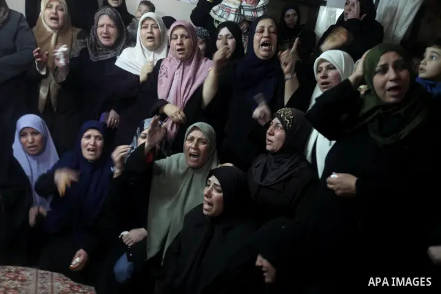 Palestinian female relatives of Ahmed Salim, one of the Nasser Salahaldin Brigades militants who was killed in an Israeli air strike, grieve during his funeral in Gaza City, on March 11, 2012. Photo by Ashraf Amra