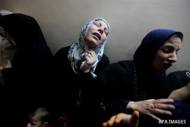Palestinian female relatives of Ahmed Salim, one of the Nasser Salahaldin Brigades militants who was killed in an Israeli air strike, grieve during his funeral in Gaza City, on March 11, 2012. Photo by Ashraf Amra