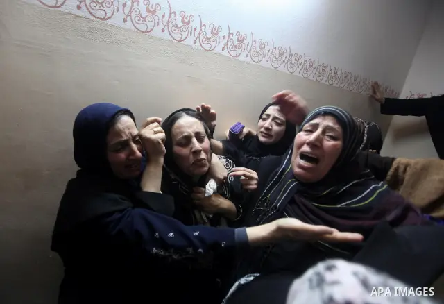 Palestinian female relatives of Ahmed Salim, one of the Nasser Salahaldin Brigades militants who was killed in an Israeli air strike, grieve during his funeral in Gaza City, on March 11, 2012. Photo by Ashraf Amra