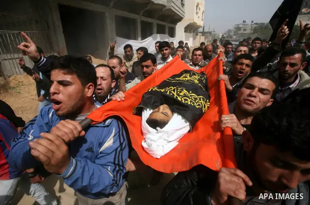 Palestinians carry the body of a 12 year old Ayoub Assalya during his funeral in Jabaliya Refugee Camp, Gaza Strip Sunday, March 11, 2012. The worst round of violence in more than a year between Israel and Gaza Strip Pal...