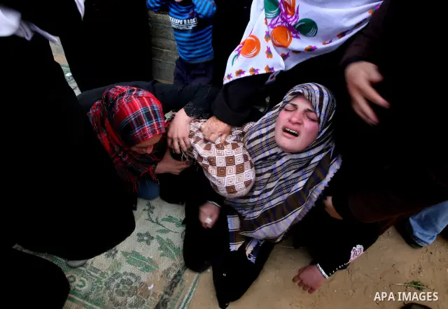 Palestinians women react during the funeral of 12 year old Ayoub Assalya killed in an Israeli airstrike in Jabaliya Refugee Camp, Gaza Strip Sunday, March 11, 2012. The worst round of violence in more than a year between...