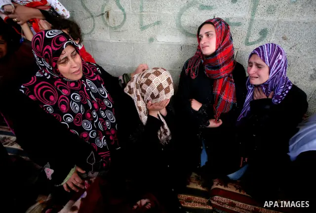Palestinians women react during the funeral of 12 year old Ayoub Assalya killed in an Israeli airstrike in Jabaliya Refugee Camp, Gaza Strip Sunday, March 11, 2012. The worst round of violence in more than a year between...