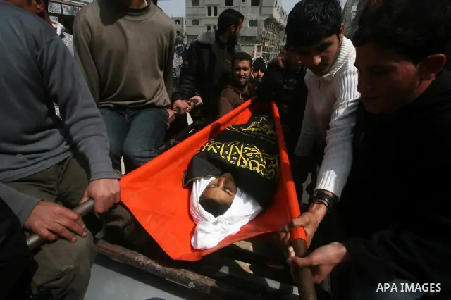 Palestinians carry the body of a 12 year old Ayoub Assalya during his funeral in Jabaliya Refugee Camp, Gaza Strip Sunday, March 11, 2012. The worst round of violence in more than a year between Israel and Gaza Strip Pal...