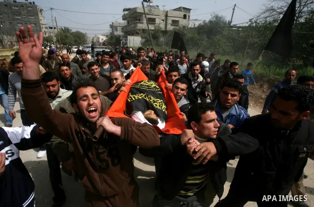 Palestinians carry the body of a 12 year old Ayoub Assalya during his funeral in Jabaliya Refugee Camp, Gaza Strip Sunday, March 11, 2012. The worst round of violence in more than a year between Israel and Gaza Strip Pal...