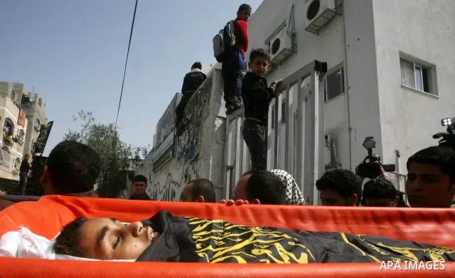 Palestinians carry the body of a 12 year old Ayoub Assalya during his funeral in Jabaliya Refugee Camp, Gaza Strip Sunday, March 11, 2012. The worst round of violence in more than a year between Israel and Gaza Strip Pal...