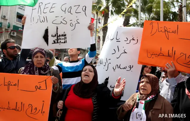Dozens of Palestinians take part in a protest in the center of the West Bank city of Ramallah to show their support for the Gaza Strip and against Israeli air strikes, on March 11, 2012. Israel will continue air strikes...