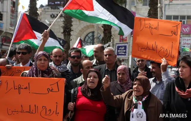 Dozens of Palestinians take part in a protest in the center of the West Bank city of Ramallah to show their support for the Gaza Strip and against Israeli air strikes, on March 11, 2012. Israel will continue air strikes...