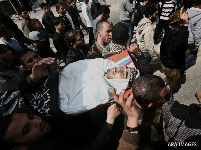 Palestinians carry the body of Ahmed Salim during his funeral in Gaza Strip Sunday, March 11, 2012. The worst round of violence in more than a year between Israel and Gaza Strip Palestinians deepened Sunday with deadly I...