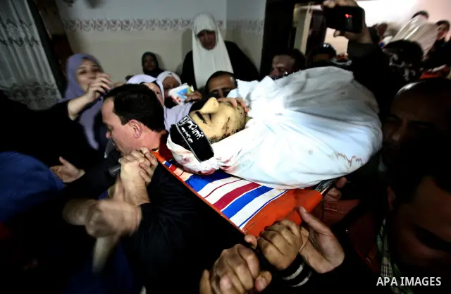 Palestinian relatives of Ahmed Salim, one of the Nasser Salah Addin Brigades who was killed in an Israeli air strike, mourn during his funeral in Gaza City,Sunday, March 11, 2012. Medics said Israeli air strikes on the G...