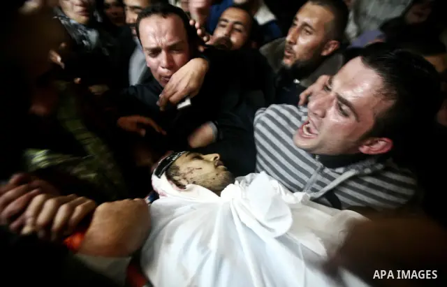 Palestinian relatives of Ahmed Salim, one of the Nasser Salah Addin Brigades who was killed in an Israeli air strike, mourn during his funeral in Gaza City,Sunday, March 11, 2012. Medics said Israeli air strikes on the G...