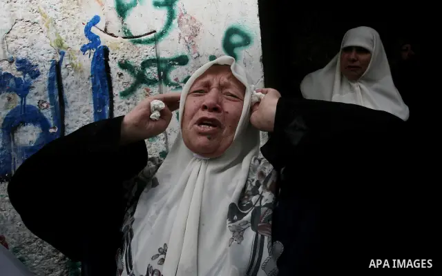 Palestinian relatives of Ahmed Salim, one of the Nasser Salah Addin Brigades who was killed in an Israeli air strike, mourn during his funeral in Gaza City,Sunday, March 11, 2012. Medics said Israeli air strikes on the G...