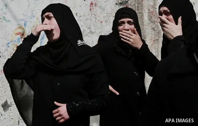 Palestinian relatives of Ahmed Salim, one of the Nasser Salah Addin Brigades who was killed in an Israeli air strike, mourn during his funeral in Gaza City,Sunday, March 11, 2012. Medics said Israeli air strikes on the G...