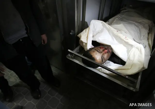 A Palestinian militant body is transported at a hospital Khan Younis in the southern Gaza Strip on March 12, 2012. Israeli air strikes killed two Palestinian militants and wounded 25 civilians in the Gaza Strip on Monday...
