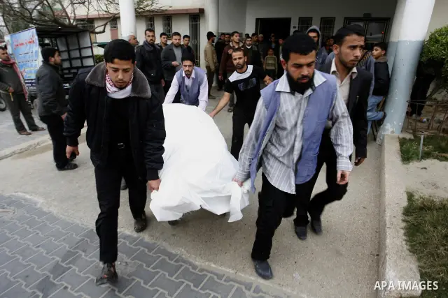 A Palestinian militant body is transported at a hospital Khan Younis in the southern Gaza Strip on March 12, 2012. Israeli air strikes killed two Palestinian militants and wounded 25 civilians in the Gaza Strip on Monday...