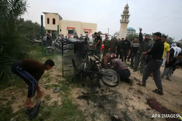 A Palestinian man reacts next to a rickshaw following an Israeli air strike in Khan Younis in the southern Gaza Strip March 12, 2012. Israeli air strikes killed two Palestinian militants and wounded 25 civilians in the G...