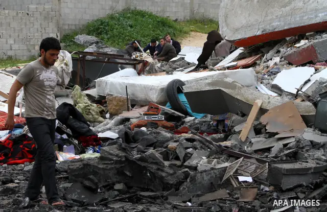 Palestinians inspect the destruction after an Israeli air strike on a building in the northern Gaza Strip refugee camp of Jabalia on March 12, 2012. Israel launched a spate of air strikes killing at least two Palestinian...