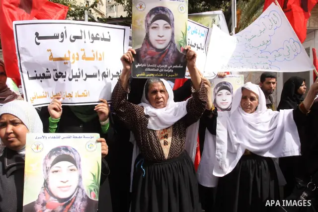 Palestinian women demonstrate in solidarity with Hana'a Shalabi during a protest in Gaza City, on Mar. 12, 2012. Shalabi, released by Israel in a prisoner swap last year but re-arrested earlier this month and held withou...