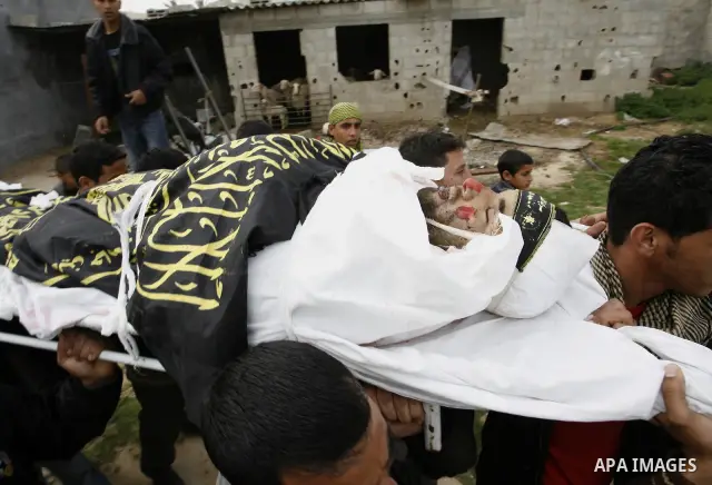 Palestinian mourners carry the body of Raafat Abu Eid , 24-years-old, a member of the Islamic Jihad's armed wing, the Al-Quds Brigades, during his funeral in Khan Yunis in the southern Gaza Strip, on March 12, 2012. Eid...