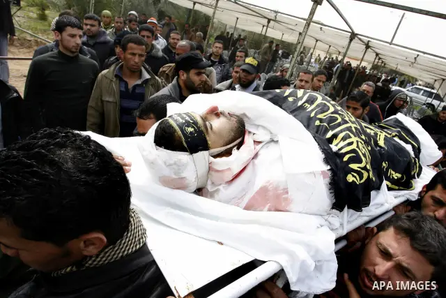 Palestinian mourners carry the body of Raafat Abu Eid , 24-years-old, a member of the Islamic Jihad's armed wing, the Al-Quds Brigades, during his funeral in Khan Yunis in the southern Gaza Strip, on March 12, 2012. Eid...