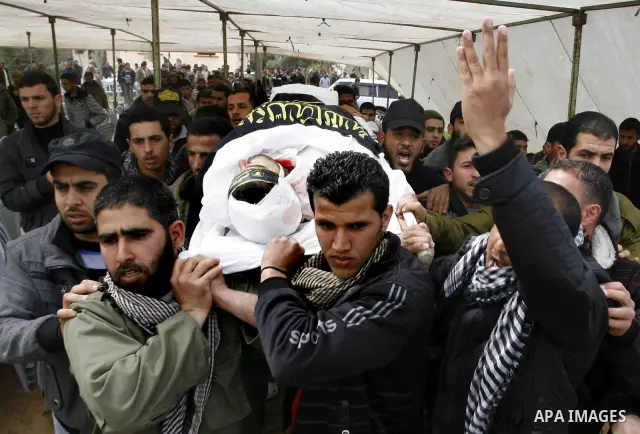 Palestinian mourners carry the body of Raafat Abu Eid , 24-years-old, a member of the Islamic Jihad's armed wing, the Al-Quds Brigades, during his funeral in Khan Yunis in the southern Gaza Strip, on March 12, 2012. Eid...