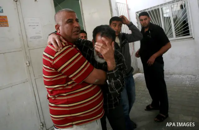 Relatives of of Mohammed al-Hasoma, 65, mourn during his funeral in Beit Lahiya, northern Gaza Strip, Monday, March 12, 2012. The cross-border violence, touched off by Israel's killing of a top militant leader on Friday,...