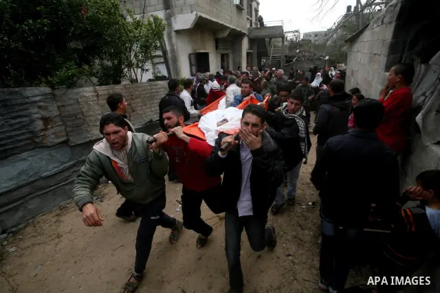 Palestinian carry the body of Mohammed al-Hasoma, 65, killed in an Israeli air strike during his funeral in Beit Lahiya, northern Gaza Strip, Monday, March 12, 2012. The cross-border violence, touched off by Israel's kil...