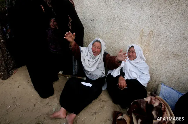 Relatives of of Mohammed al-Hasoma, 65, mourn during his funeral in Beit Lahiya, northern Gaza Strip, Monday, March 12, 2012. The cross-border violence, touched off by Israel's killing of a top militant leader on Friday,...