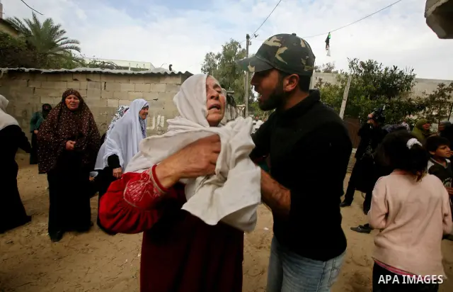 Relatives of of Mohammed al-Hasoma, 65, mourn during his funeral in Beit Lahiya, northern Gaza Strip, Monday, March 12, 2012. The cross-border violence, touched off by Israel's killing of a top militant leader on Friday,...