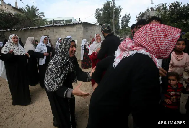 Relatives of of Mohammed al-Hasoma, 65, mourn during his funeral in Beit Lahiya, northern Gaza Strip, Monday, March 12, 2012. The cross-border violence, touched off by Israel's killing of a top militant leader on Friday,...