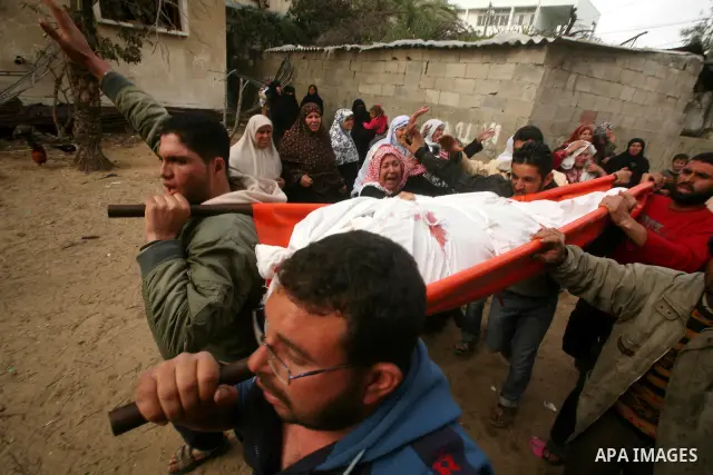 Palestinian carry the body of Mohammed al-Hasoma, 65, killed in an Israeli air strike during his funeral in Beit Lahiya, northern Gaza Strip, Monday, March 12, 2012. The cross-border violence, touched off by Israel's kil...