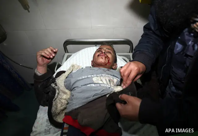 A wounded Palestinian boy is wheeled into a hospital in Gaza City, after an Israeli air strike March 12, 2012. Israeli air strikes killed two Palestinian militants and a civilian in the Gaza Strip on Monday in a fourth d...