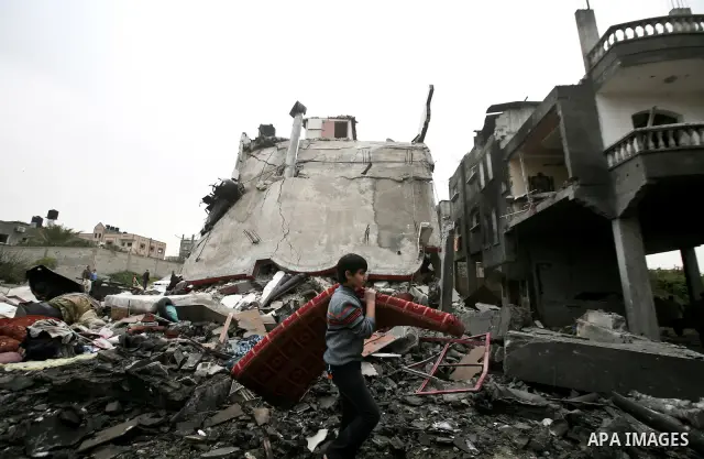 A Palestinian children in the rubble of a destroyed building following an Israeli air strike in the east of Jabaliya refugee camp on, 12 March 2012. Reports state that an Israeli air strike on the northern Gaza Strip's J...