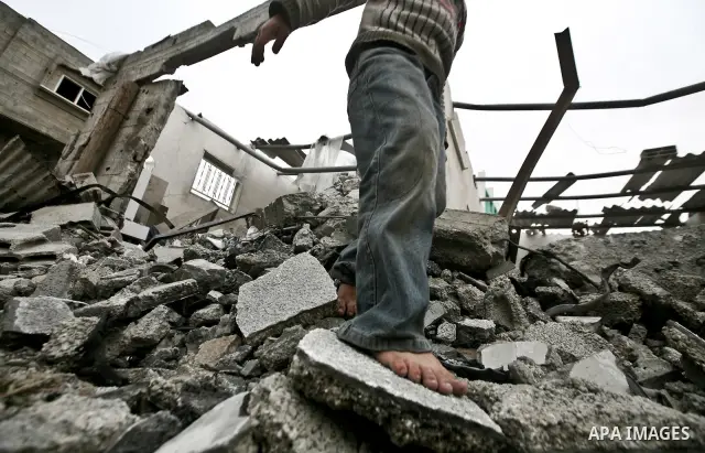 A Palestinian children in the rubble of a destroyed building following an Israeli air strike in the east of Jabaliya refugee camp on, 12 March 2012. Reports state that an Israeli air strike on the northern Gaza Strip's J...