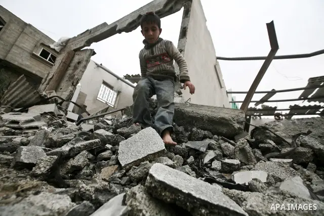 A Palestinian children in the rubble of a destroyed building following an Israeli air strike in the east of Jabaliya refugee camp on, 12 March 2012. Reports state that an Israeli air strike on the northern Gaza Strip's J...