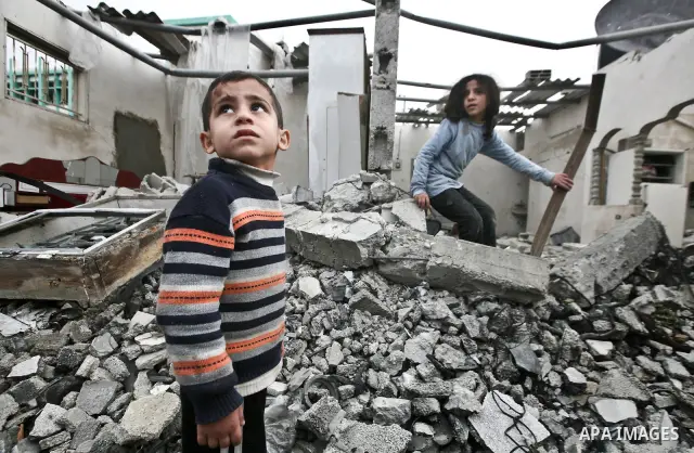 A Palestinian children in the rubble of a destroyed building following an Israeli air strike in the east of Jabaliya refugee camp on, 12 March 2012. Reports state that an Israeli air strike on the northern Gaza Strip's J...