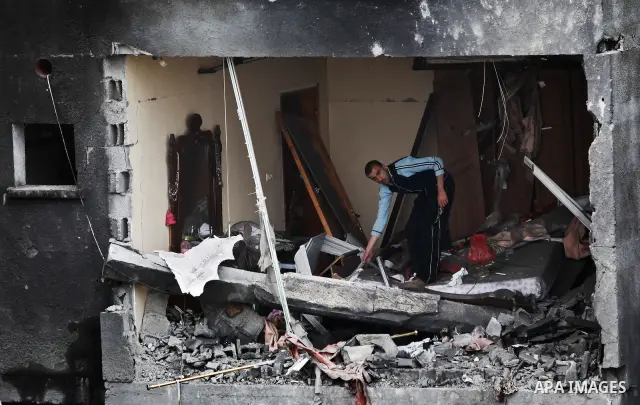 Palestinians amongst the rubble of a destroyed building of senior Islamic Jihad militant following an Israeli air strike in the east of Jabaliya refugee camp on, 12 March 2012. Reports state that an Israeli air strike on...