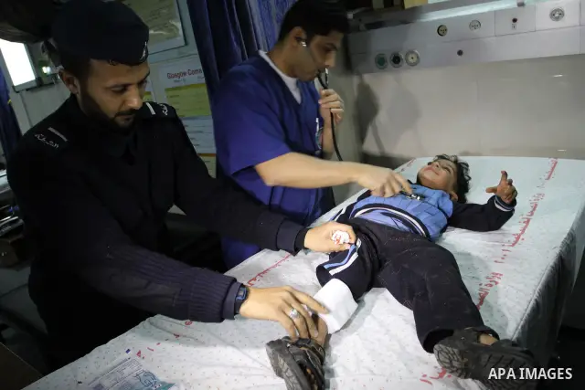 A wounded Palestinian boy is wheeled into a hospital in Gaza City, after an Israeli air strike March 12, 2012. Israeli air strikes killed two Palestinian militants and a civilian in the Gaza Strip on Monday in a fourth d...