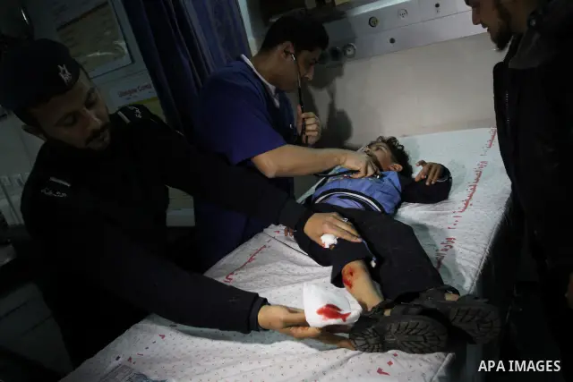 A wounded Palestinian boy is wheeled into a hospital in Gaza City, after an Israeli air strike March 12, 2012. Israeli air strikes killed two Palestinian militants and a civilian in the Gaza Strip on Monday in a fourth d...