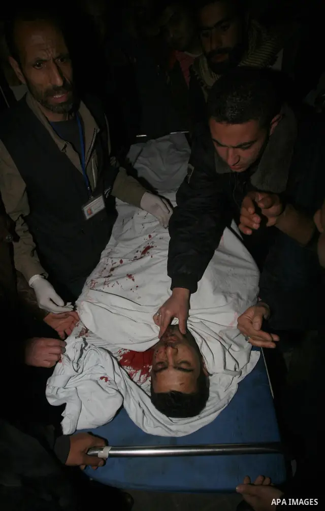 One of two Islamic Jihad militants who were killed in an Israeli airstrike on March 12, 2012 is transported into the morgue of Al-Shifa Hospital in Gaza city, as Israeli warplanes pounded Gaza for a fourth day, killing s...