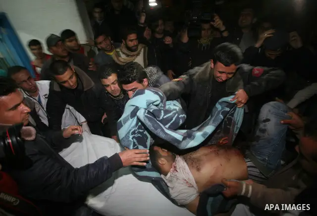 One of two Islamic Jihad militants who were killed in an Israeli airstrike on March 12, 2012 is transported into the morgue of Al-Shifa Hospital in Gaza city, as Israeli warplanes pounded Gaza for a fourth day, killing s...