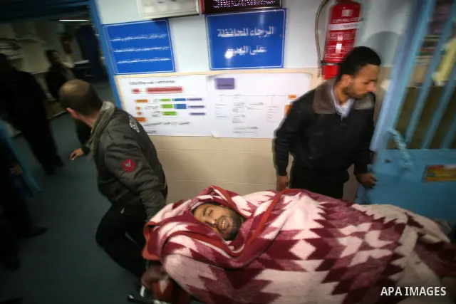 One of two Islamic Jihad militants who were killed in an Israeli airstrike on March 12, 2012 is transported into the morgue of Al-Shifa Hospital in Gaza city, as Israeli warplanes pounded Gaza for a fourth day, killing s...