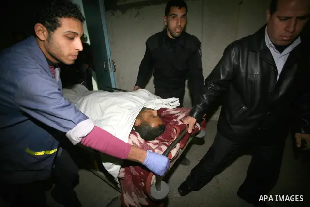 One of two Islamic Jihad militants who were killed in an Israeli airstrike on March 12, 2012 is transported into the morgue of Al-Shifa Hospital in Gaza city, as Israeli warplanes pounded Gaza for a fourth day, killing s...