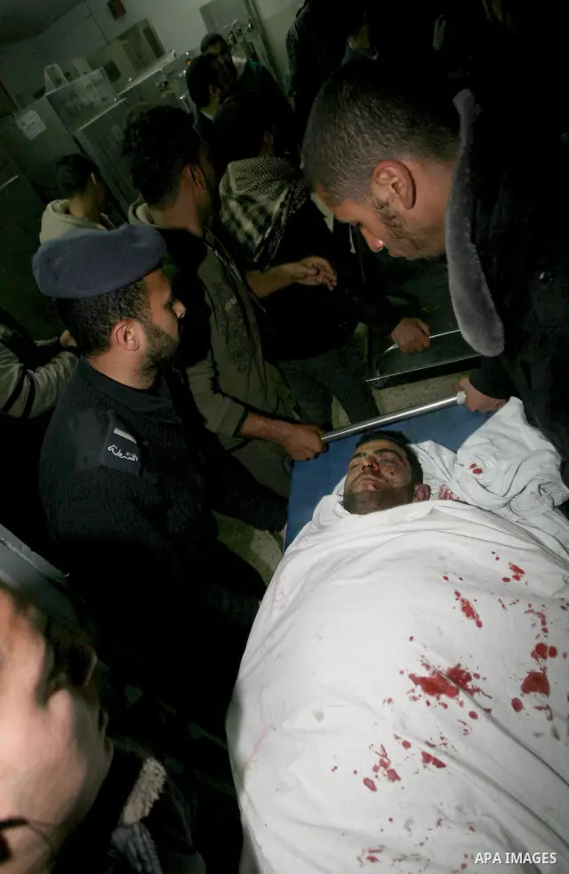 One of two Islamic Jihad militants who were killed in an Israeli airstrike on March 12, 2012 is transported into the morgue of Al-Shifa Hospital in Gaza city, as Israeli warplanes pounded Gaza for a fourth day, killing s...