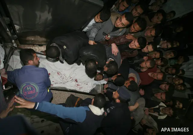 One of two Islamic Jihad militants who were killed in an Israeli airstrike on March 12, 2012 is transported into the morgue of Al-Shifa Hospital in Gaza city, as Israeli warplanes pounded Gaza for a fourth day, killing s...