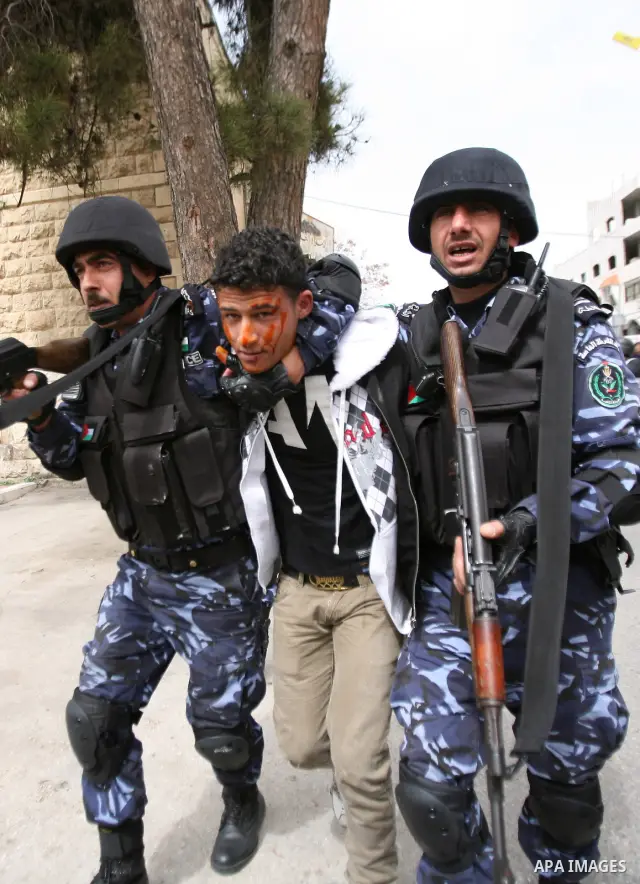 Members of the Palestinian security forces make a mock arrest during a training drill in the West Bank city of Hebron March 12, 2012. Photo by Mamoun Wazwaz