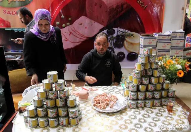 Palestinians attend exhibition for Palestinian food in Gaza City on Mar. 13, 2012. to support the Palestinian national products. Photo by Mohammed Asad