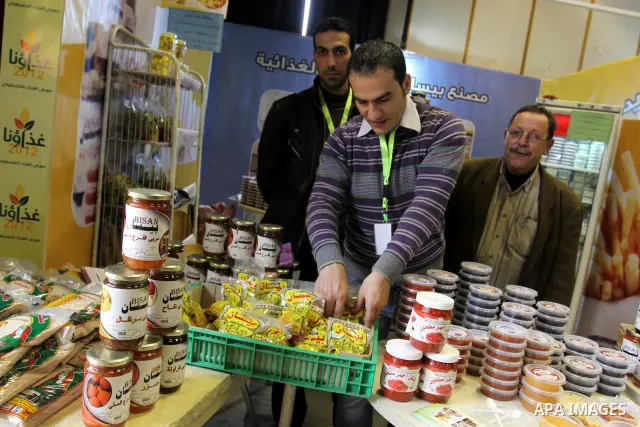 Palestinians attend exhibition for Palestinian food in Gaza City on Mar. 13, 2012. to support the Palestinian national products. Photo by Mohammed Asad