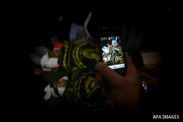 Palestinians mourn beside the bodies of two Islamic Jihad militants Mohammed Daher, left, and Bassam Al Ejla killed in an Israeli air strike in Gaza Tuesday, during their funeral in Gaza City, Tuesday, March 13, 2012 . I...