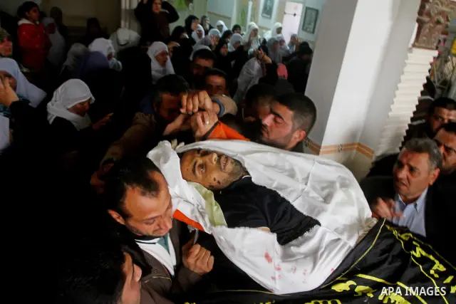 Palestinian relatives of Islamic Jihad militant Bassam El-Ejla, who was killed the night before along with another comrade in an Israeli air strike, mourn during his funeral in Gaza City on March 13, 2012. Israel and mil...